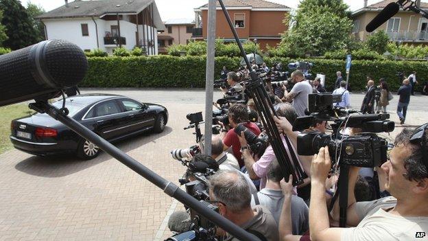 Reporters gather outside the care home where former Italian Premier Silvio Berlusconi was ordered to perform four hours of community service a week for a year