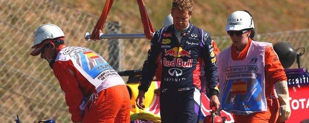 Sebastian Vettel walks away from his Red Bull