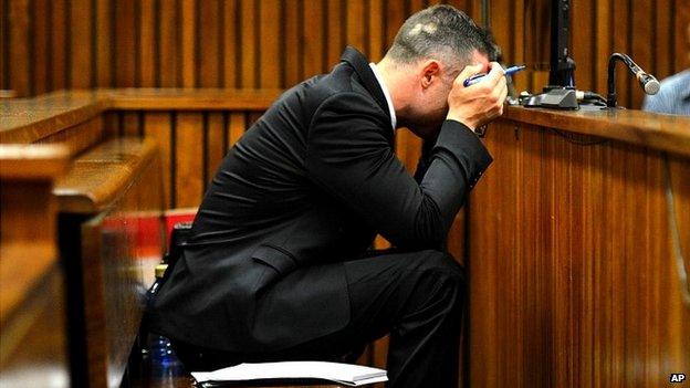 Oscar Pistorius cradles his head in his hands during court proceedings in Pretoria - 5 May 2014