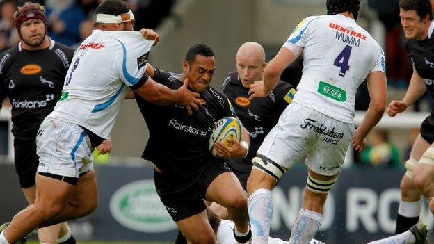 Sinoti Sinoti of Newcastle Falcons forces his way past Hoana Tui of Exeter Chiefs