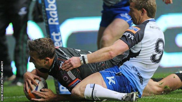 Ashley Beck scores the second Ospreys try despite Kieran Marmion's efforts