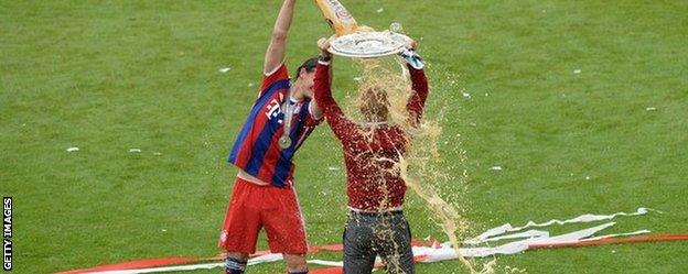 Bayern Munich manager Pep Guardiola is showered in beer after his team's final game of the season