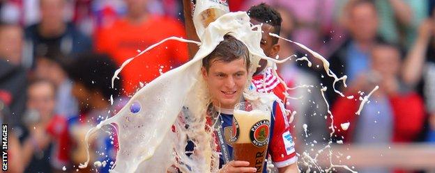 Bayern Munich's Jerome Boateng pours beer over team-mate Toni Kroos