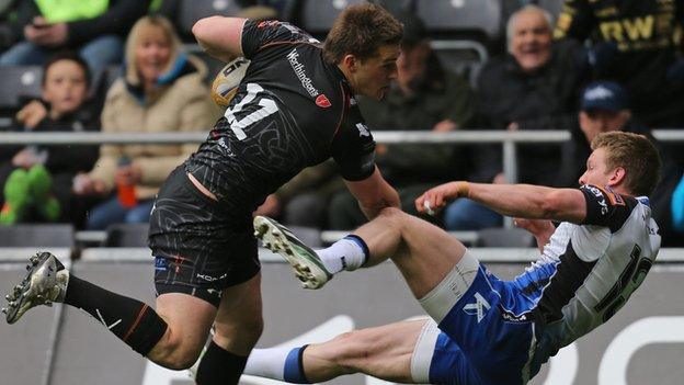 Jeff Hassler barges past Eoin Griffin to score the first Ospreys try at the Liberty Stadium