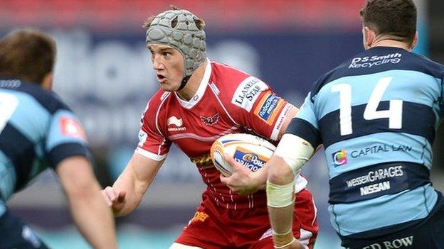 Jonathan Davies takes on Blues Simon Humberstone (left) and Alex Cuthbert