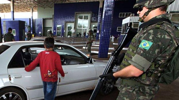 Brazilian Army soldiers stand guard at the Puente de Amistad in Foz do Iguacu, Parana, bordering with Paraguay"s Ciudad del Este, during security operations to prevent weapons and explosives smuggling ahead of the upcoming Brazil 2014 FIFA World Cup, on April 29