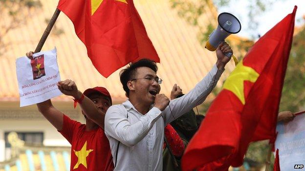 Protesters shout slogans outside the Chinese embassy