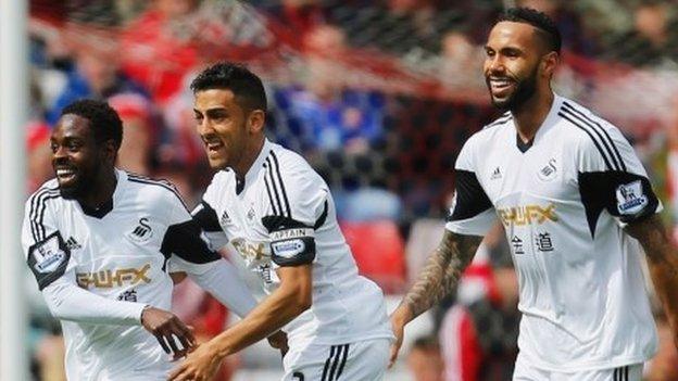 Nathan Dyer (l) celebrates Swansea's opener with Neil Taylor and Kyle Bartley (r)