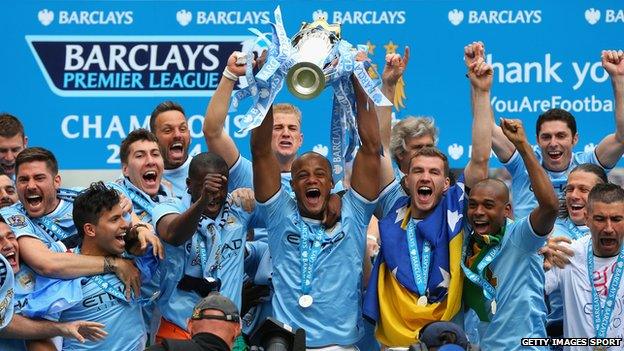 Vincent Kompany of Manchester City lifts the Premier League trophy at the end of the Barclays Premier League match between Manchester City and West Ham United