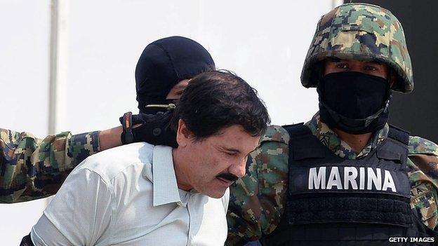 Mexican drug trafficker Joaquin Guzman is escorted by marines as he is presented to the press on 22 February, 2014