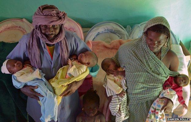 Parents holding their quadruplets