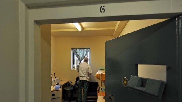 A prisoner in a cell at Wormwood Scrubs, a Category B prison in London.