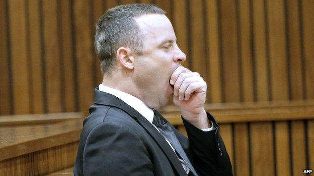 South African Paralympic athlete Oscar Pistorius yawns in the dock during his trial in Pretoria (12 May 2014)