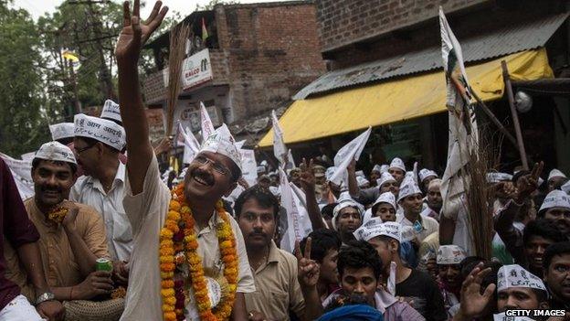 AAP leader Arvind Kejriwal waves to supporters during a rally in Varanasi