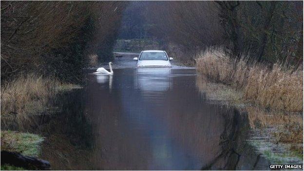 A car drives through flood water near Langport