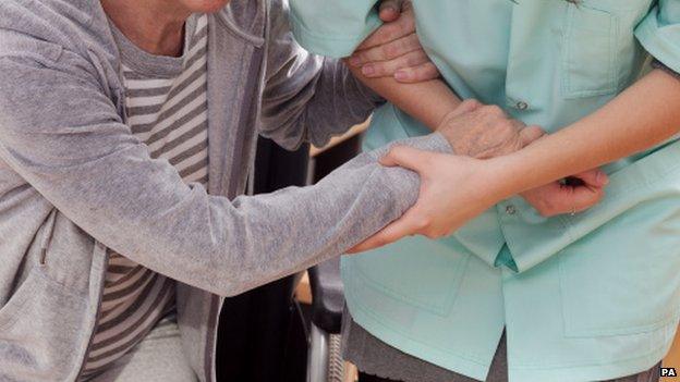 Nurse helping elderly person