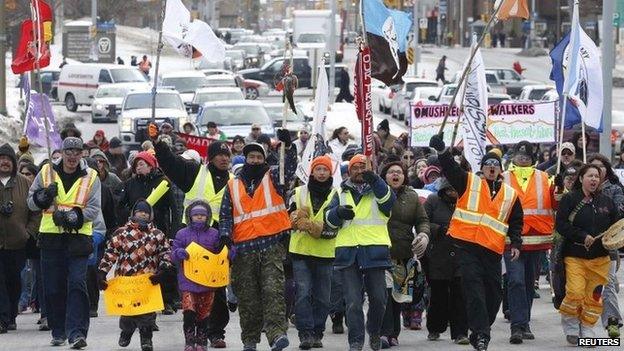 Members of the "Omushkegowuk Walkers" and their supporters march towards Parliament Hill 24 February 2014