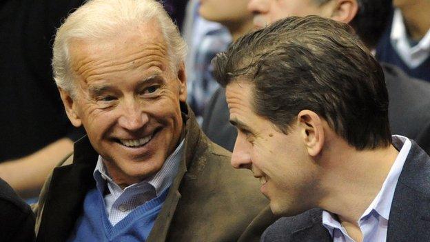 Joe Biden (left) talks with his son Hunter at basketball game in 2010.