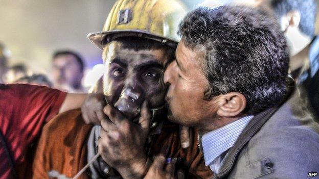 Man kisses son after his rescue from the mine in Soma, Manisa, Turkey, on 13 May 2014