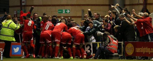 Dean Cox is mobbed after scoring against Peterborough