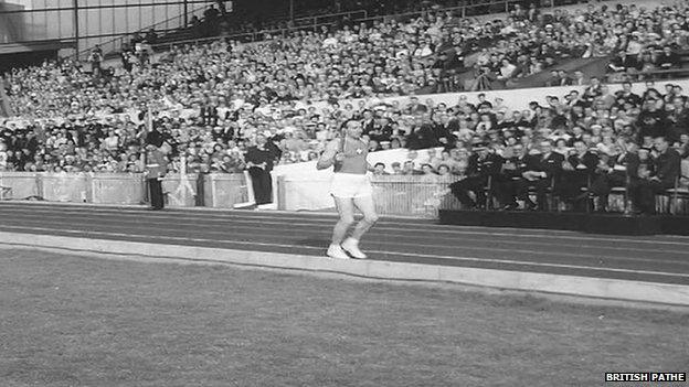 Ken Jones brings baton into stadium