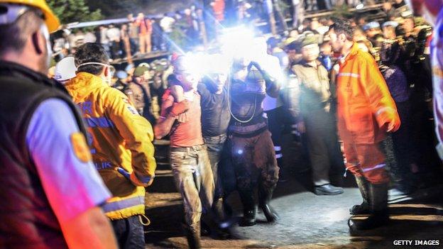 A miner is helped by friends after an explosion in Soma on 13 May 2014.