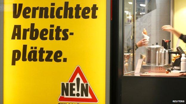 A poster against minimum wage in front of a snack bar in Zurich