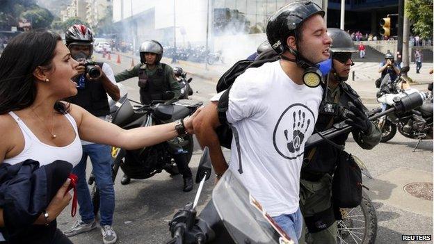 Police detain an anti-government protester during an anti-governemnt protest in Caracas, May 14, 2014.