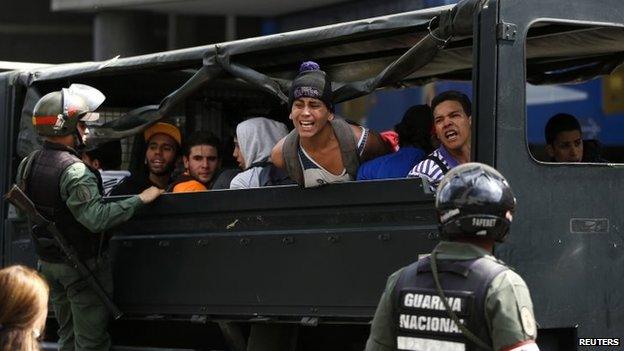 Anti-government protesters shout from a truck after being detained in Caracas, May 14, 2014.