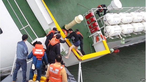 Screen grab taken from a video released by Korea Coast Guard on 28 April shows the sunken South Korea ferry Sewol captain Lee Joon-Seok wearing a sweater and underpants being rescued from the tilting vessel before it sank on 16 April