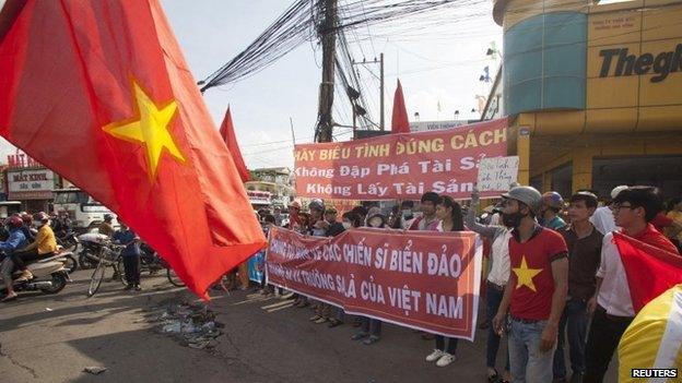 Workers hold banners during a protest in an industrial zone in Binh Duong province on 14 May 2014