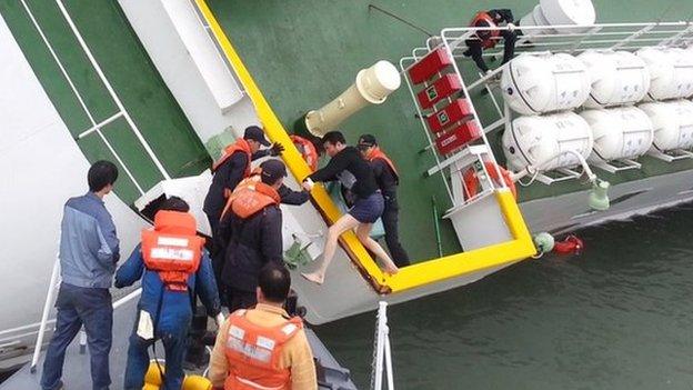 Screen grab taken from a video released by Korea Coast Guard on 28 Aprishows the sunken South Korea ferry Sewol captain Lee Joon-Seok wearing a sweater and underpants being rescued from the tilting vessel before it sank on 16 April