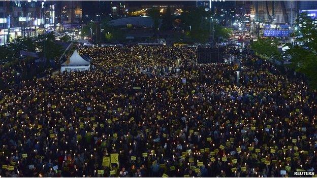 People attend a candlelight vigil to commemorate victims of the sunken Sewol passenger ferry in Ansan on 10 May