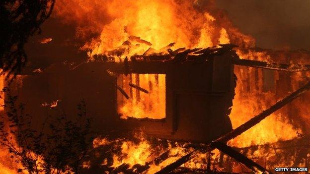 A house is consumed by a wildfire in San Marcos, California, 14 May 2014