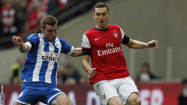 Arsenal's Belgian defender Thomas Vermaelen (left) vies with Wigan Athletic's striker Callum McManaman