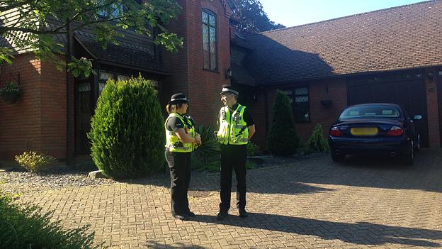 Police outside the home of Paul and Sandra Dunham