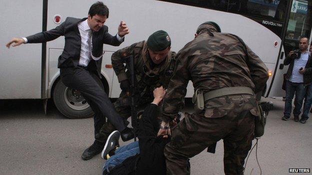 Erdogan aide Yusuf Yerkel (left) kicks a protester in Soma, Turkey, on 14 May 2014