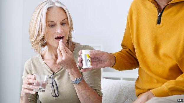 Woman taking pill