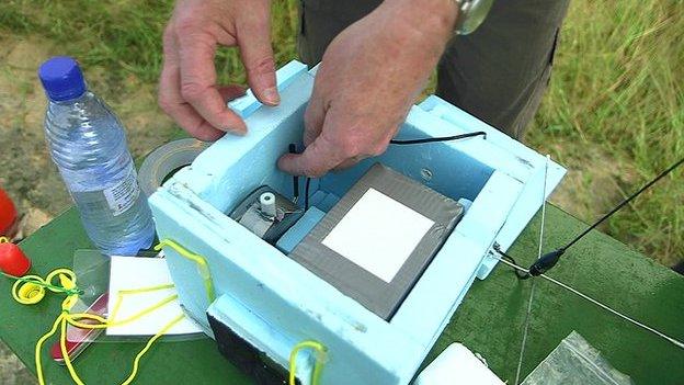 Instruments which will study the stratosphere are fitted into a protective box