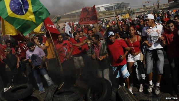 Members of the Workers Without a Roof Movement protest near the Arena Corinthians stadium in Sao Paulo against the upcoming Fifa World Cup (15 May 2014)