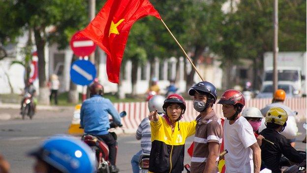 Protesters stand on the corner of a street in Quan Doan 4, Binh Duong province, near Song Than 2 Industrial Park in Vietnam, on 14 May.