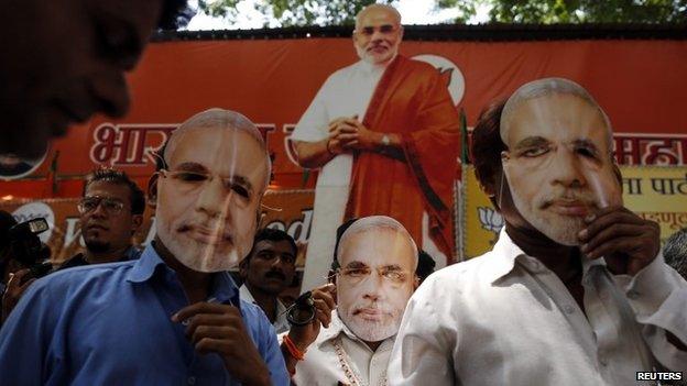 Supporters of Hindu nationalist Narendra Modi, prime ministerial candidate for India"s main opposition Bharatiya Janata Party (BJP), wear masks depicting Modi outside their party office in Mumbai