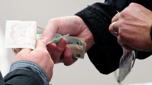 Bookmaker handing over cash