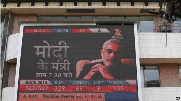 A portrait of India's next prime minister Narendra Modi is displayed on a screen on the façade of the Bombay Stock Exchange in Mumbai, India, Friday, May 16, 2014.