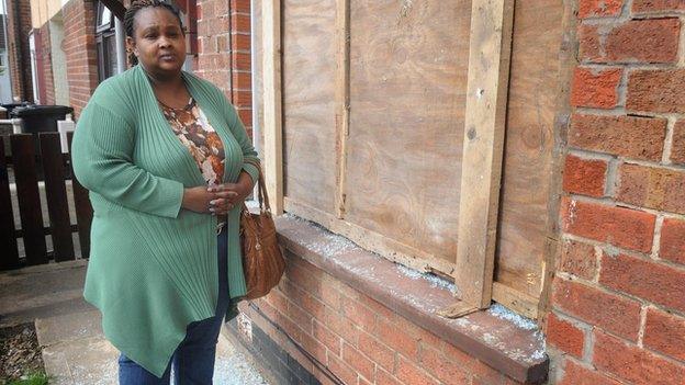 Kerry Ann Brown looks at the damage to her window