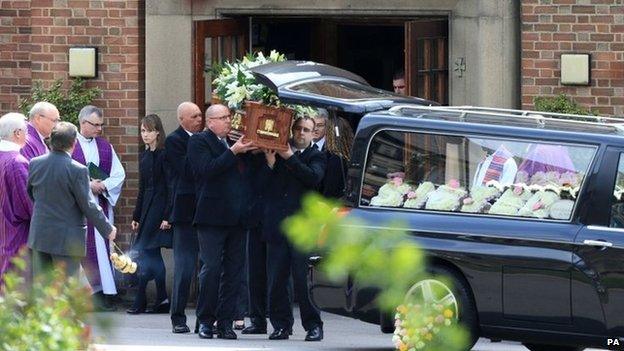 Ann Maguire's coffin is placed into hearse