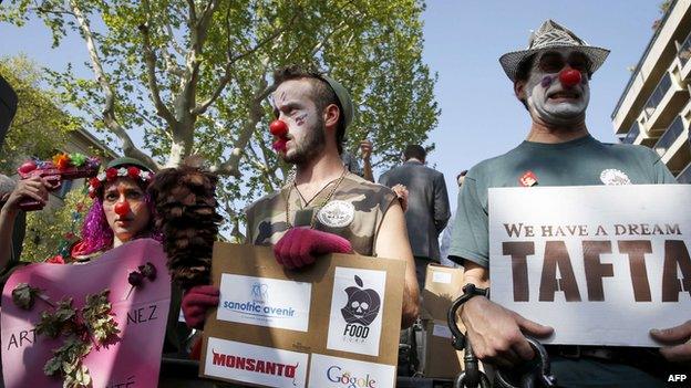 Demonstrators dressed as clowns take part in a rally against transatlantic trade agreements, Paris, April 2014