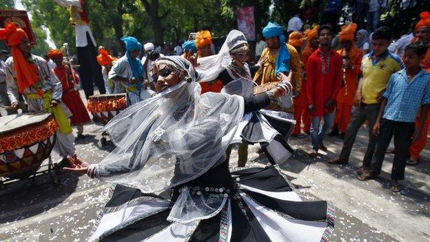 A BJP supporter of BJP dances outside party headquarters in New Delhi