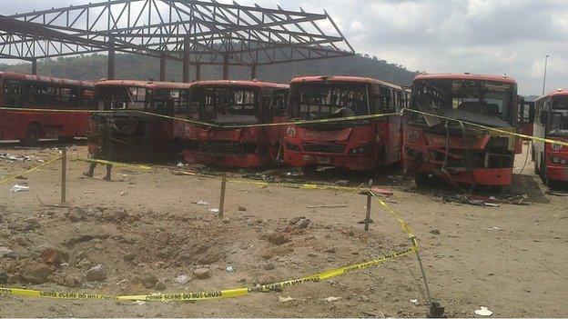 Damaged buses following blast at bus station outside Abuja on 14 April 2014