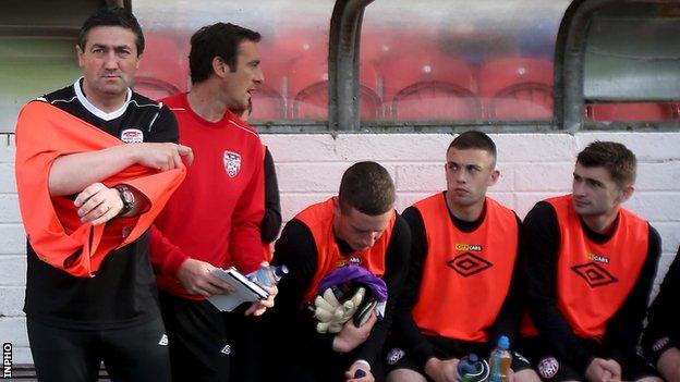 Peter Hutton (left) watches Friday's match from the Derry dugout